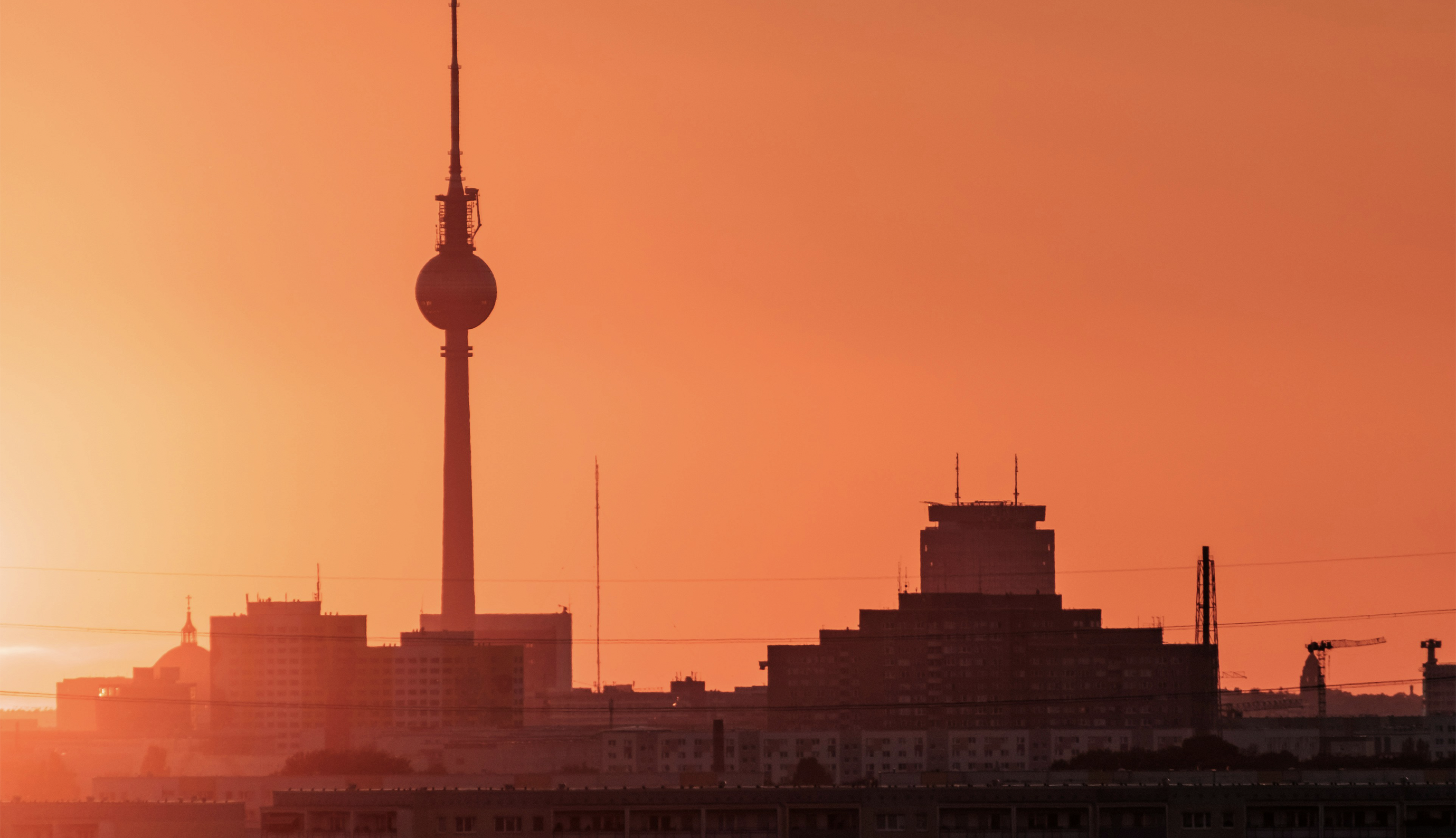 A sunrise over Berlin, tinting the sky orange